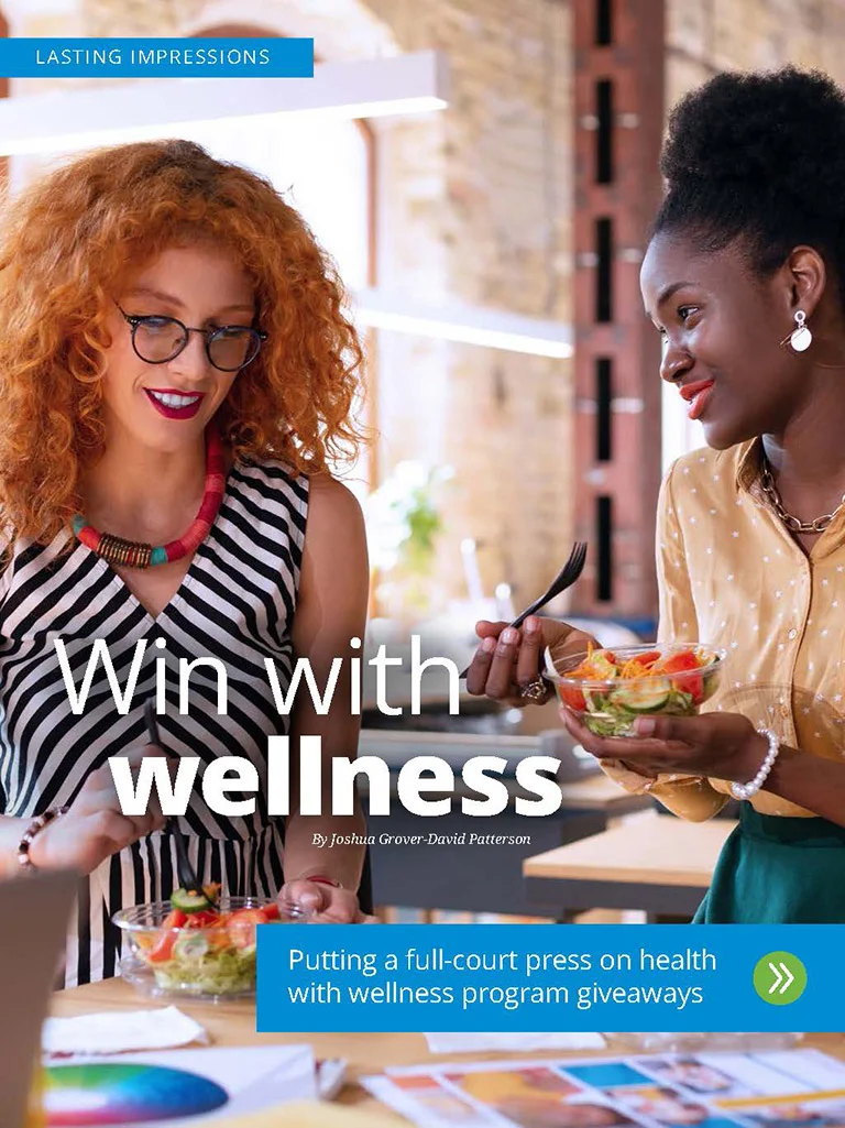 Two women eating a salad at work